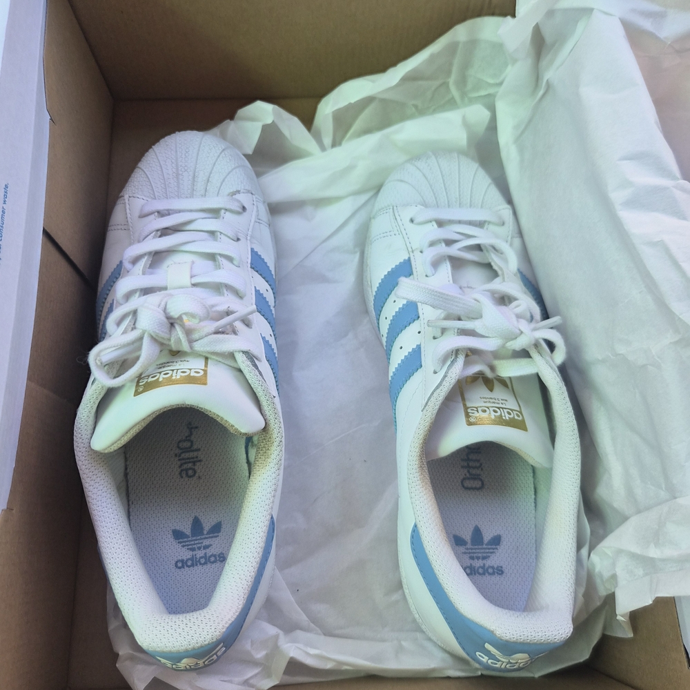 Adidas WomensWhite Sneakers with Light Blue Stripes